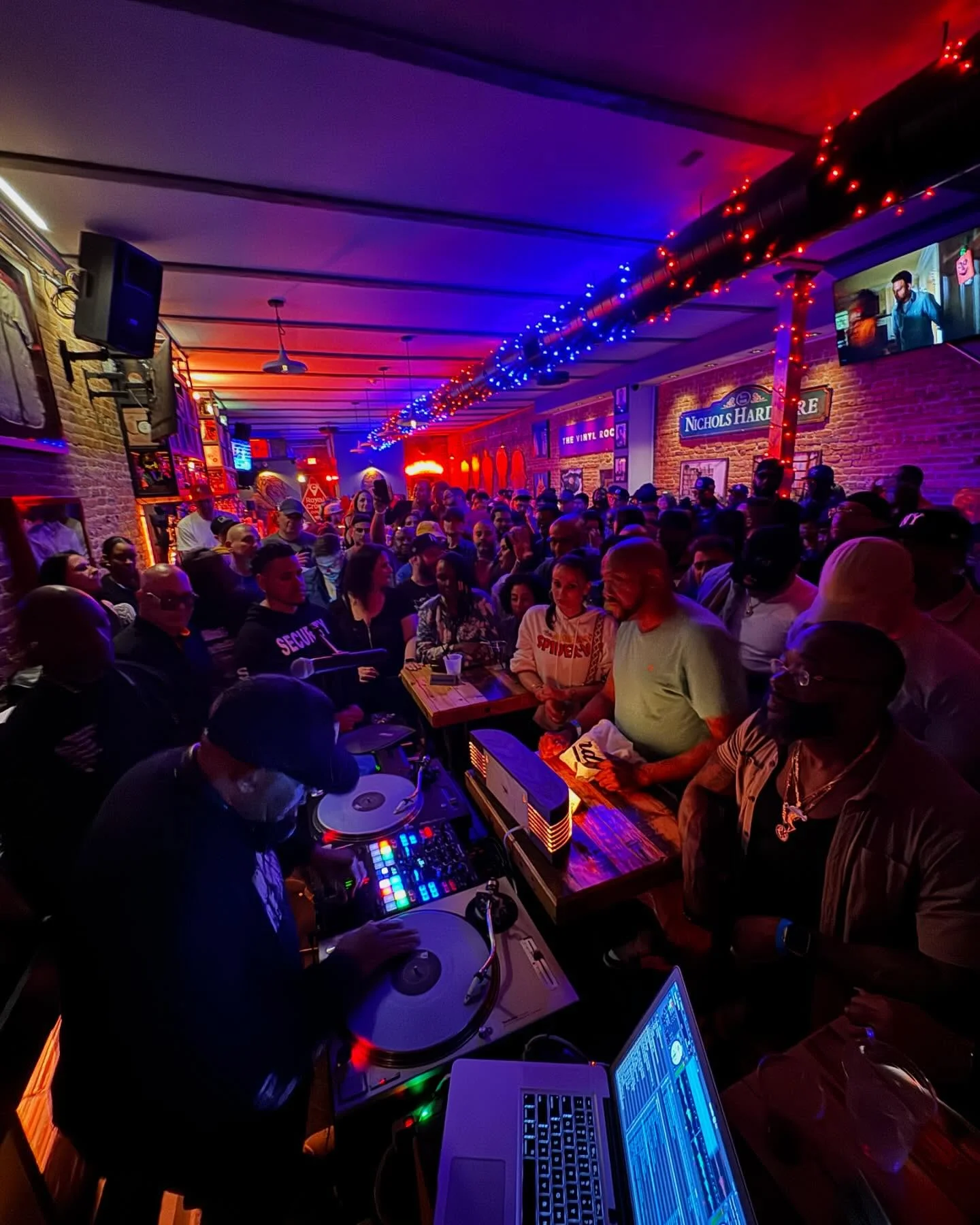 A packed night at The Vinyl Room with DJ and energetic crowd
